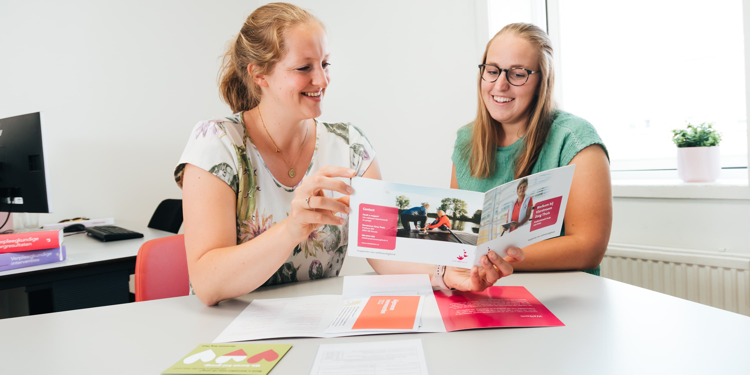 Foto van een medewerker of een groep medewerkers van Vierstroom Zorg Thuis die hun werk doen of samen plezier hebben, met een uitstraling van passie, betrokkenheid en gezelligheid