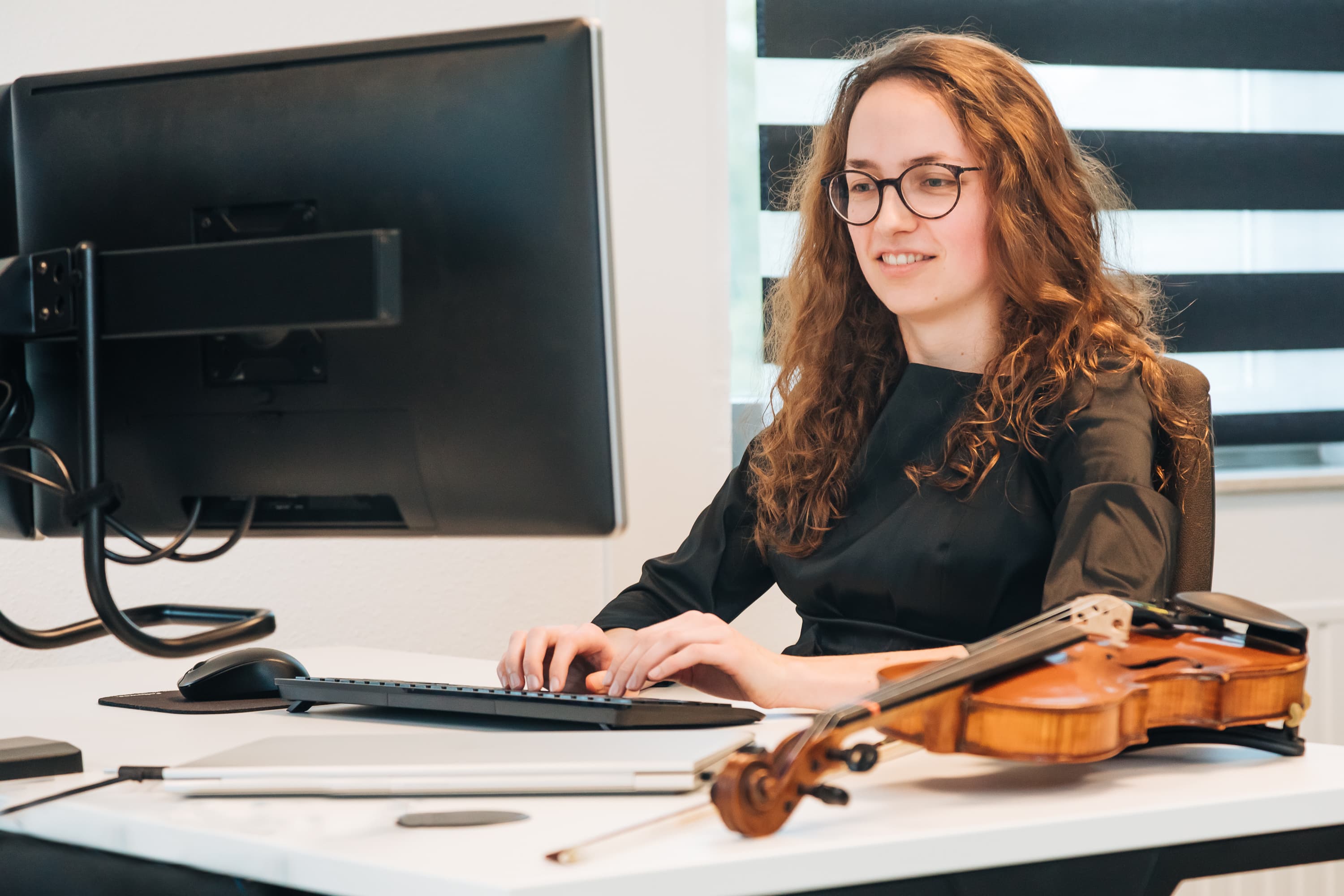 Employer Branding van een ‘Young Professional’ van Lansigt, werkend, lachend of poserend in een van de vestigingen van het accountantskantoor, namelijk Gouda.