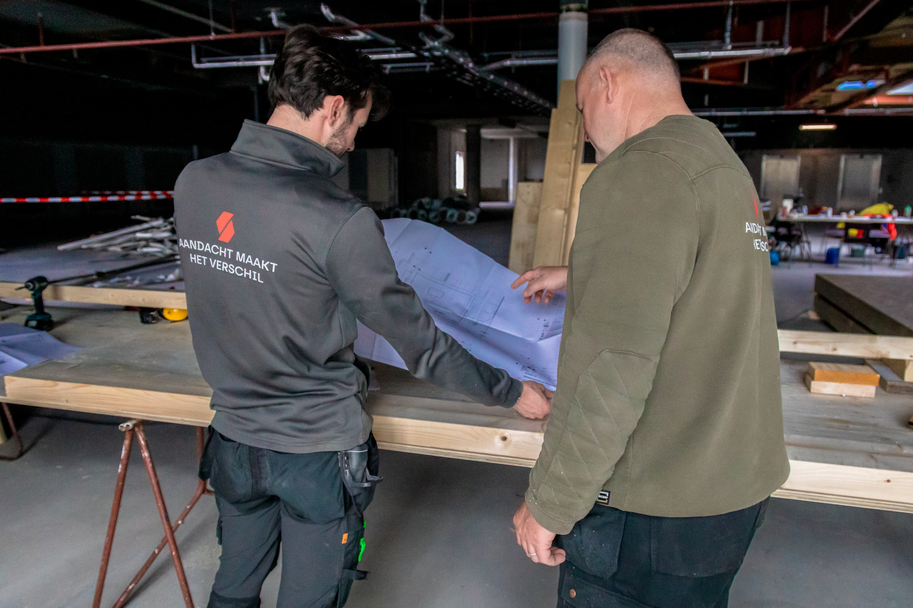 Fotoserie van Bart van den Bosch bij SKN Bouw in de Mall of the Netherlands. De beelden tonen bouwvakkers in bedrijfskleding van ViV Corporate Fashion, met aandacht voor details, vakmanschap en teamspirit.